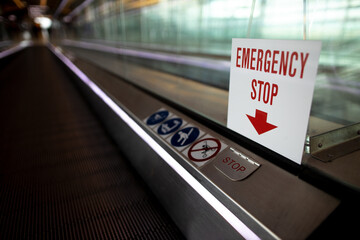 Safety switch red emergency stop on escalator warning sign, symbol