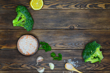 Broccoli, garlic, lemon slice and pink himalayan salt. Food background with copy space for text, ingredients for cooking