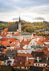 Fototapeta na wymiar Aerial view of houses and medieval St. Vitus Church in Cesky Krumlov in the Czech Republic