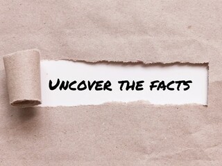 Phrase UNCOVER THE FACTS appearing behind torn brown paper.For background purpose.