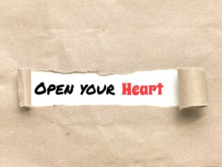 Phrase OPEN YOUR HEART appearing behind torn brown paper.For background purpose.