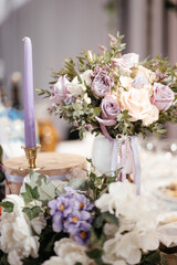 wedding bouquet on the table next to the candles