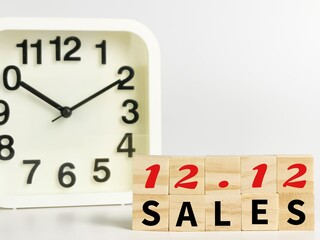 Text 12.12 SALES on wooden cubes with alarm clock isolated on white background.Business concept.