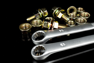 wrenches, nuts and bolts of yellow metal close-up