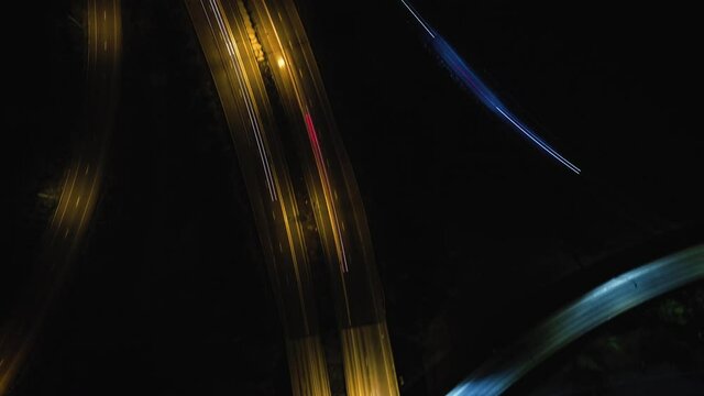 Drone Top View Hyperlapse Over Intersecting Freeway Ramps at Night