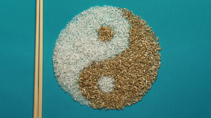 Light and dark rice. Yin and Yang symbol. On a turquoise background.