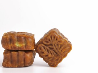 Selective focus photo with noise effect of square shape moon cake isolated on white background.