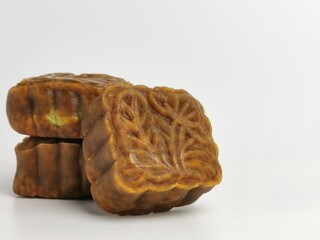 Selective focus photo with noise effect of square shape moon cake isolated on white background.