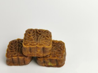 Selective focus photo with noise effect of square shape moon cake isolated on white background.