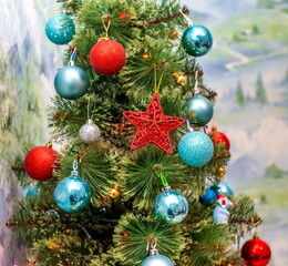 Obraz na płótnie Canvas Part of an artificial Christmas tree with toys close-up