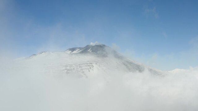 Etna with a view of the South East crater after a snowfall and the spectacular Valle del Bove with its dikes and solidified lava flows. Sicily. Italy.