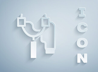Paper cut Slingshot icon isolated on grey background. Paper art style. Vector.