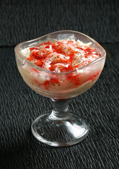 Pakistani famous desert sweet payasam with strawberry syrup ice cream bowl black background 