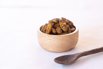 
silkworm pupa in wooden bow as edible insects on white background, high protein insect