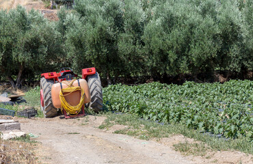 Old tractor parked near the field in the countryside