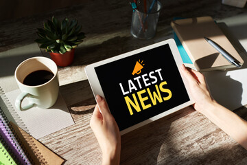 Latest news text and icon on device screen. Business internet and technology concept.