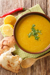 Lebanese Lentil Soup Shorbat Adas closeup in the bowl on the table. Vertical top view above