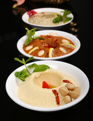 Arabic Turkish starter appetizer humus chickpeas eggplant black background 