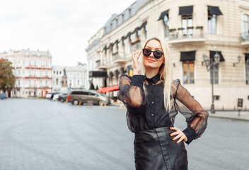 Portrait of fashionable stylish blonde woman in sunglasses in european city © splitov27