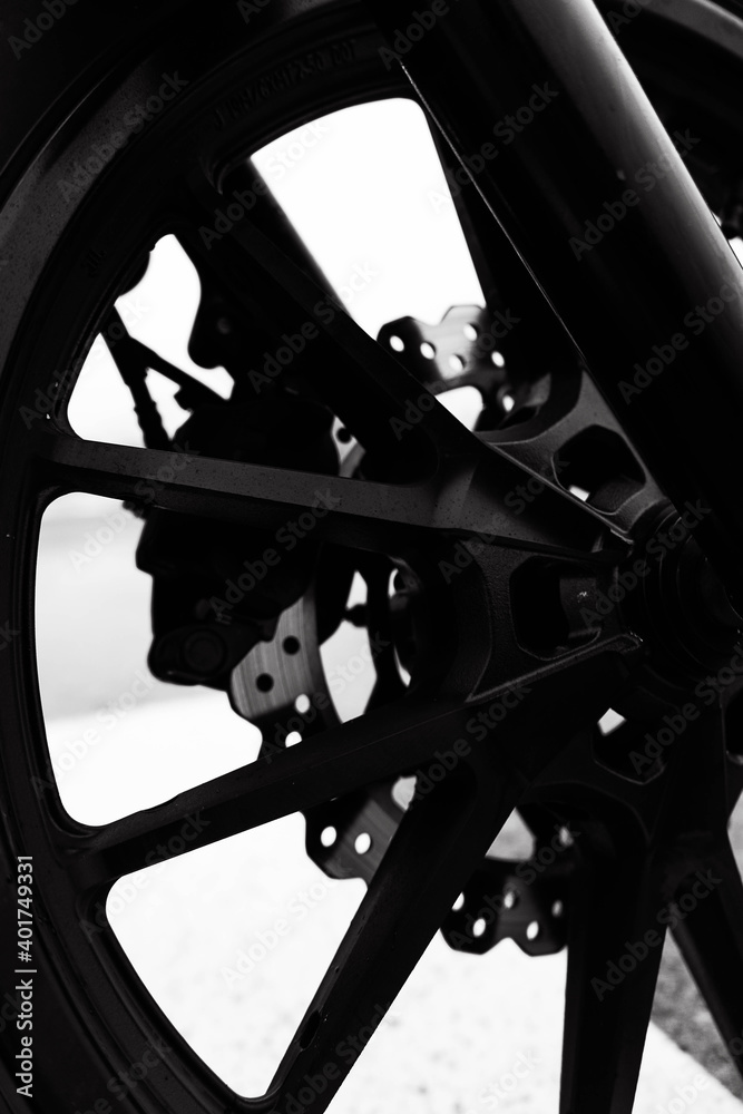 Canvas Prints A vertical shot of a black motorcycle wheel