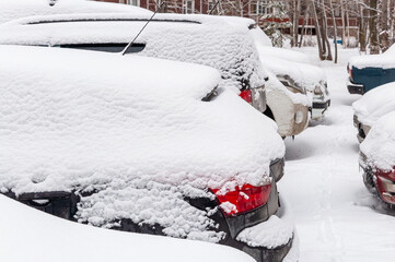 Cars covered with a thick layer of snow