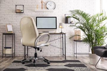 Comfortable chair near desk in modern office interior