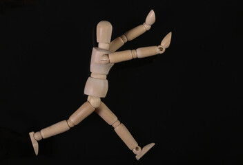 Wooden puppet mannequin isolated on black background