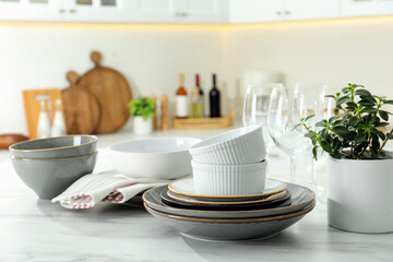 Set of beautiful tableware on white table in kitchen