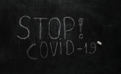 Obraz premium Words STOP! covid-19 chalk hand drawn on blackboard