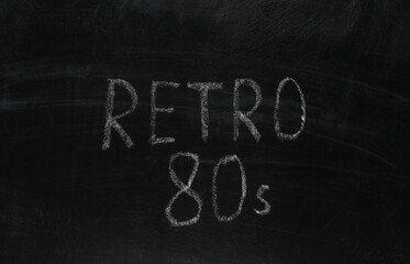 Word retro 80s chalk hand drawn on blackboard