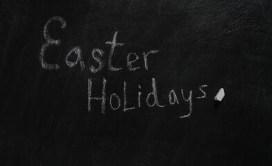 Slogan Easter Holidays chalk hand drawn on blackboard