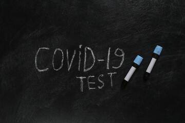 Test tubes and Words covid-19 test chalk hand drawn on blackboard