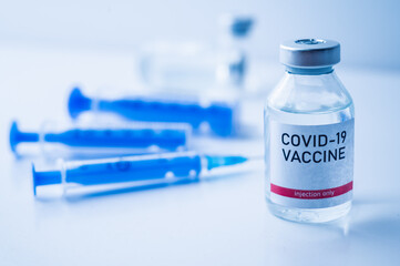 A single bottle vial of Covid-19 vaccine. Medical concept vaccination hypodermic injection...