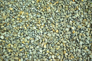 Pebble background. Fine-grained gravel. Rocky surface. Beach. Scattered stones.