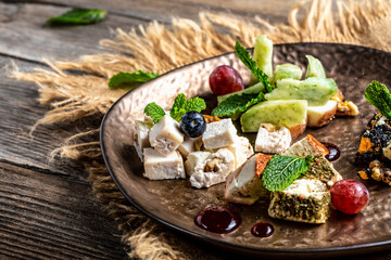 Various types of cheese on rustic wooden table The concept of eco products. Organic farm dairy products, cheeses. goat cheese. Copy space. top view