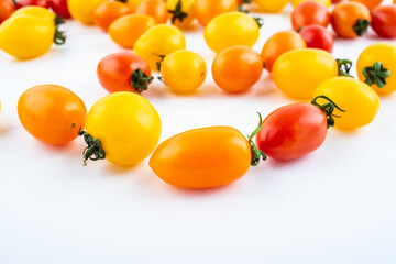 Fresh three-color cherry tomatoes on white background