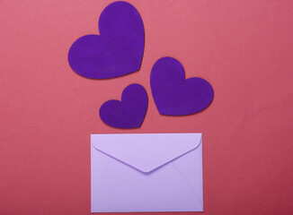 Envelope with hearts (valentines) on pink background. Valentine's Day. Top view
