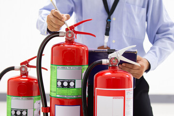 Fire engineering checking pressure gauge level of fire extinguishers tank in the building concepts...
