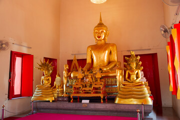Golden buddha statue in ubosot or church of Wat Makham Temple or Wat San Chao shrine for thai people and foreign travelers travel visit respect praying at Pathumthani city in Pathum Thani, Thailand