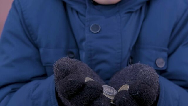 The hungry homeless boy begging on the streets and overcame a plaintive glance. Waif