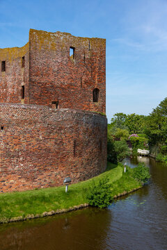 Southside with the moat of the ruin castle Teylingen in the south-holland village of Sassenheim in the Netherlands.