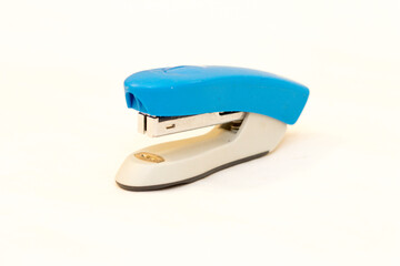 Blue and grey stapler office supplies close up isolated on the white background