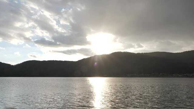 Lake Yogo in Shiga Prefecture at dusk, illuminated by strong backlighting.