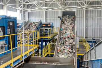 Waste sorting and recycling plant. Garbage moves on a conveyor belt