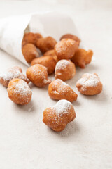 Fried beignets in a typically cornet paper, carnival food in low lands.