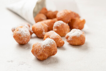 Fried beignets in a typically cornet paper, carnival food in low lands.