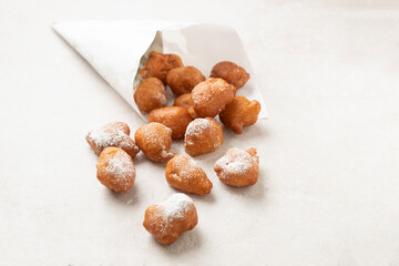 Fried beignets in a typically cornet paper, carnival food in low lands.