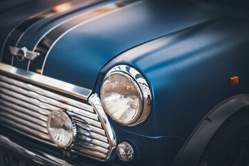Headlamps and grille of a blue classic car restored © Visual Motiv