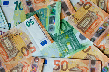 a pile of paper euro banknotes as part of the payment system of a single country