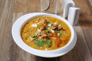 Kerala chicken curry coconut cream in bowl on wooden background 